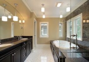 Master bath in new construction home with black tub area